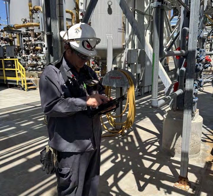 Plant operator using a tablet during rounds.